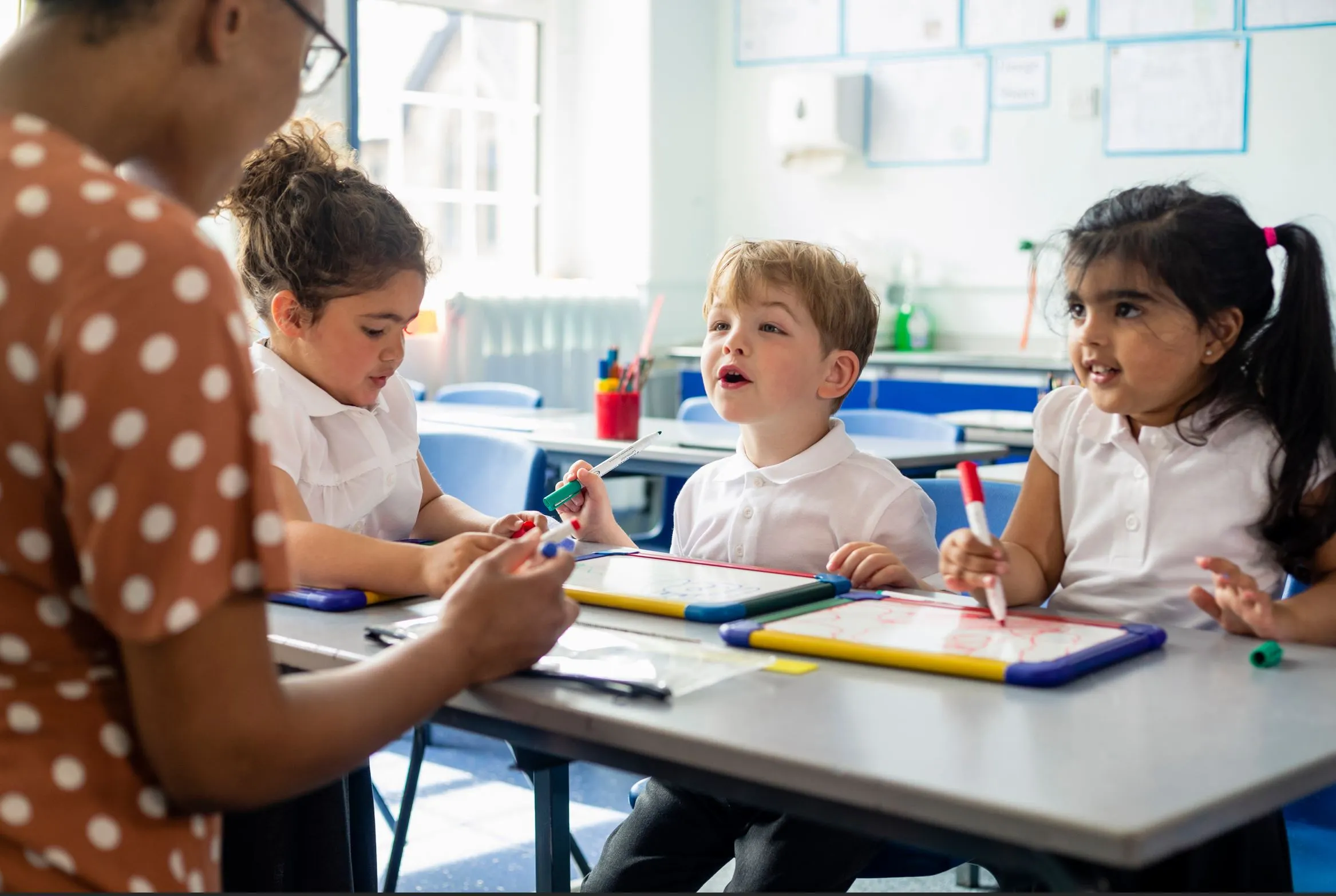A teacher exemplifying one of the 10 essential classroom management skills as her class is focused and organised.
